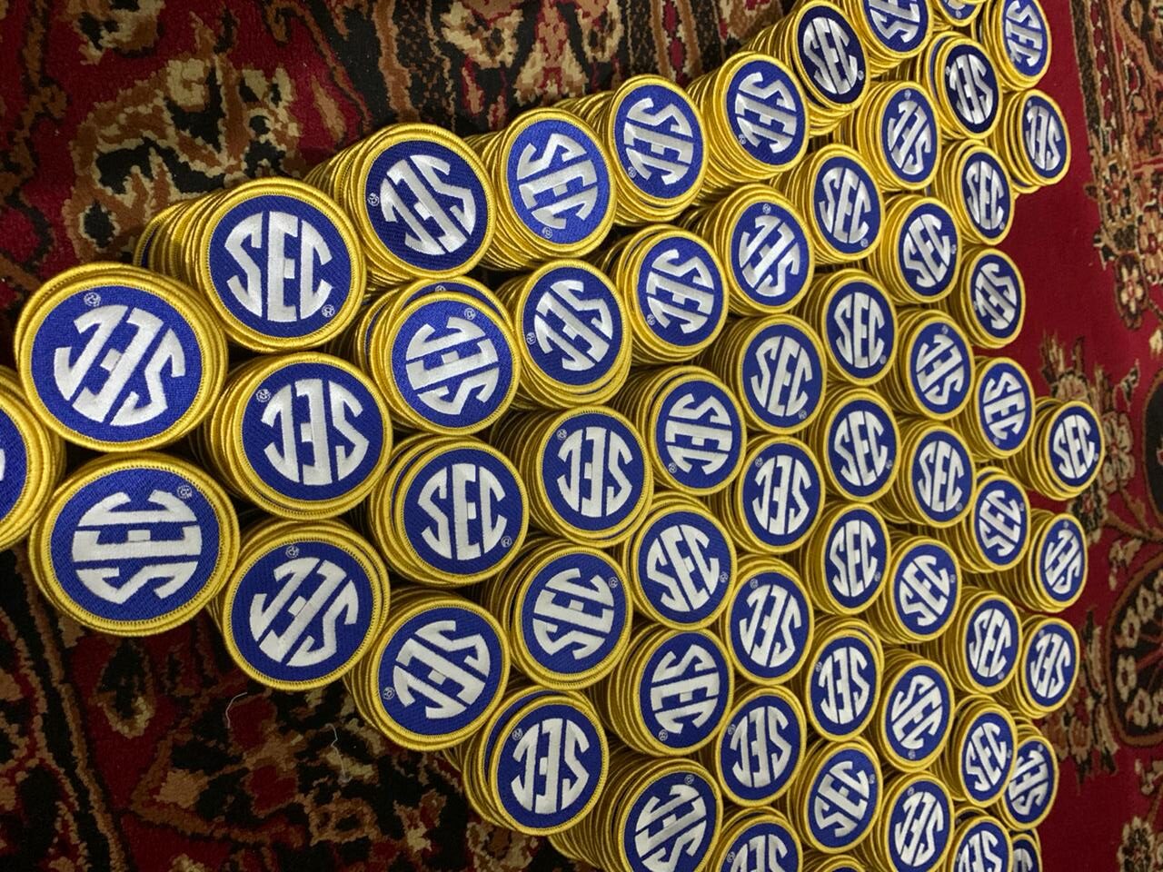 Stacks of round patches with a blue background, white 'SEC' lettering