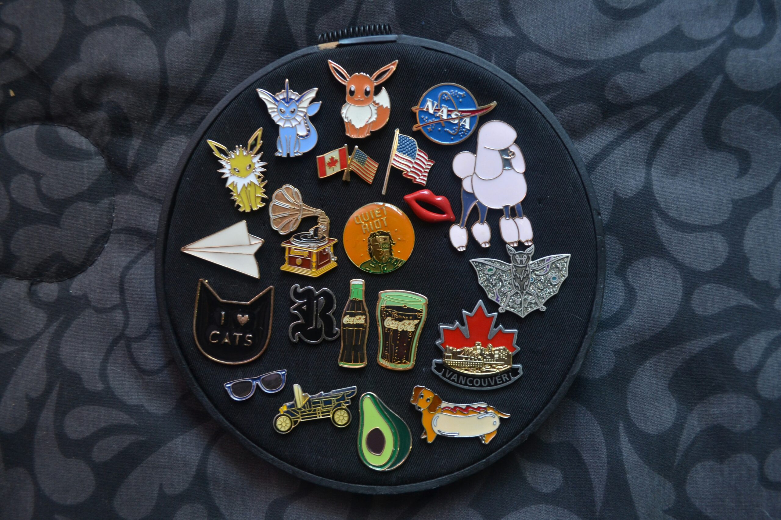 Assorted PVC patches arranged on a circular black background