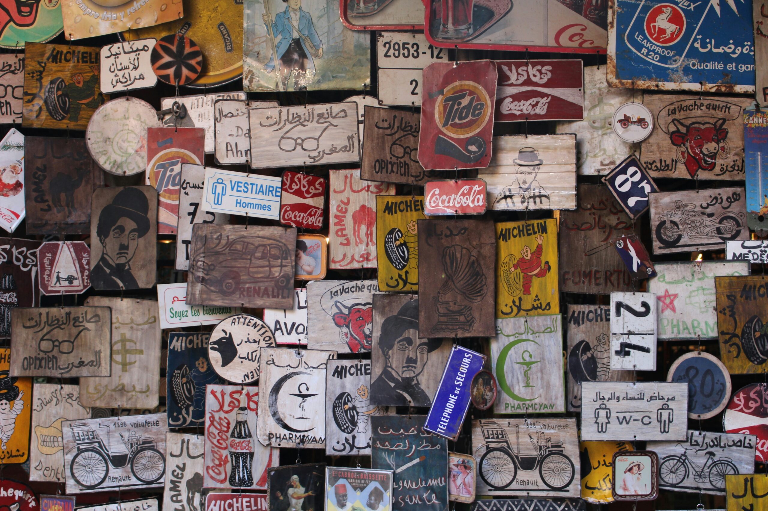 A colorful collection of vintage-inspired patches and signs displayed on a wall